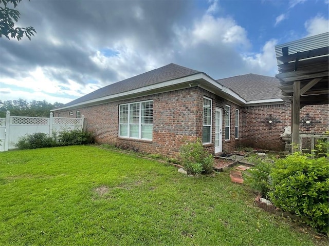 view of side of property featuring a lawn