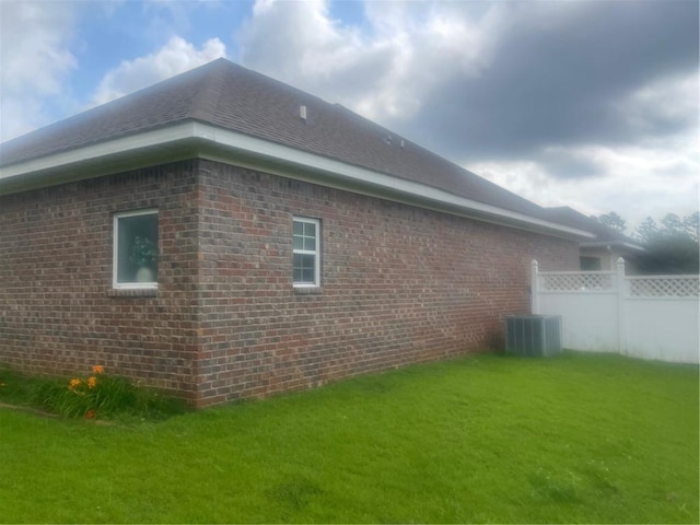 view of side of home with a yard