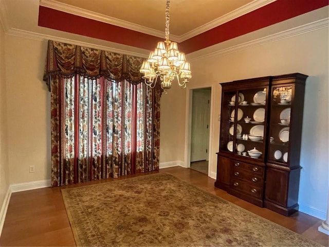 unfurnished dining area with ornamental molding, dark hardwood / wood-style floors, and a notable chandelier