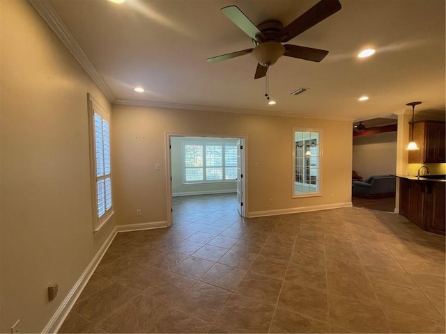 tiled empty room featuring crown molding and ceiling fan