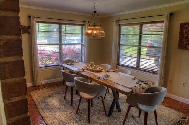 dining area with crown molding, brick floor, and baseboards