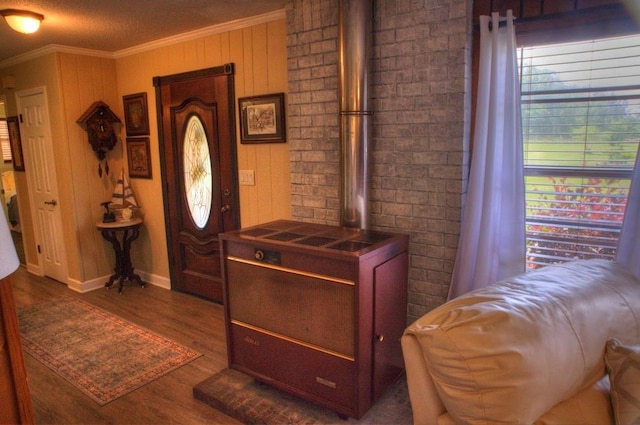 foyer entrance featuring crown molding, dark wood-style flooring, and baseboards