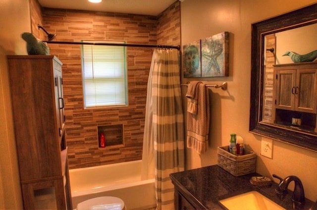 full bathroom featuring shower / bathtub combination with curtain, toilet, and vanity