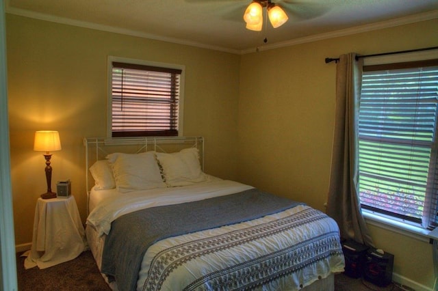 bedroom featuring ornamental molding, carpet flooring, and multiple windows