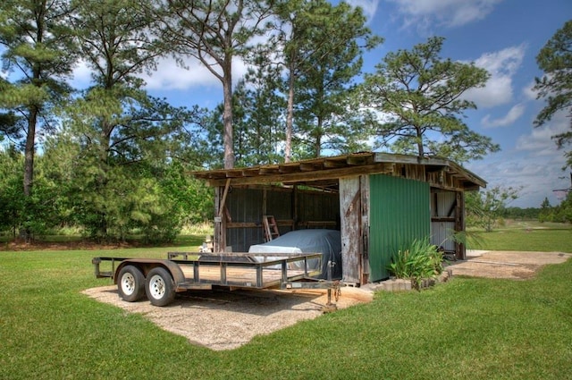 surrounding community featuring an outbuilding and a lawn