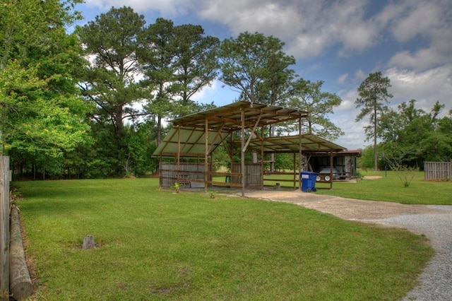 view of community featuring a yard and an outbuilding
