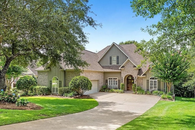 view of front of home with a garage and a front lawn