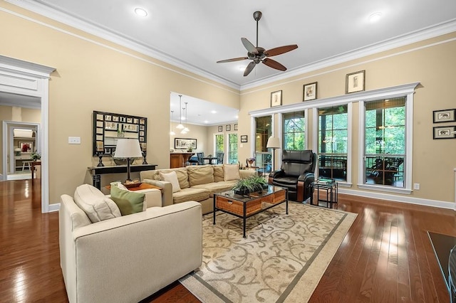 living room with ornamental molding, ceiling fan, and dark hardwood / wood-style flooring