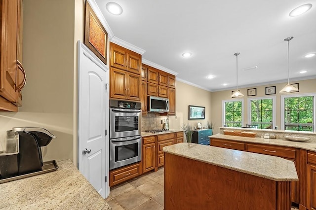 kitchen with light stone counters, crown molding, a center island, hanging light fixtures, and stainless steel appliances