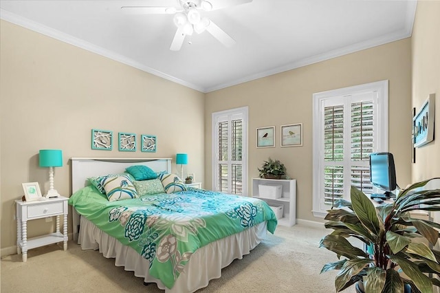 carpeted bedroom featuring crown molding and ceiling fan