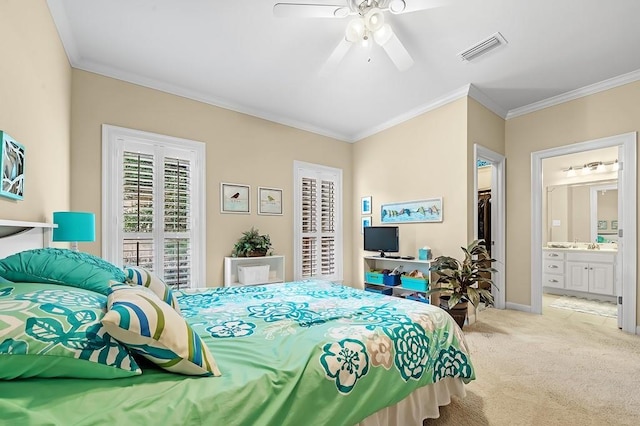 bedroom featuring ceiling fan, light colored carpet, ornamental molding, and ensuite bathroom