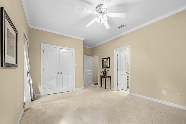 unfurnished bedroom with ceiling fan, a closet, ornamental molding, and light carpet