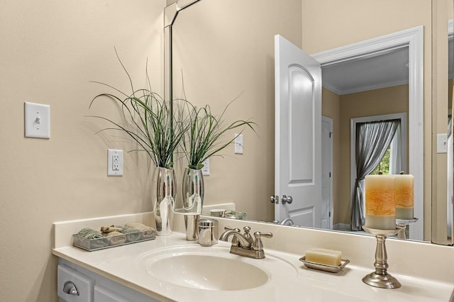 bathroom with ornamental molding and vanity