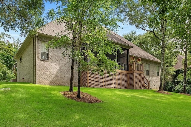 view of home's exterior featuring a yard and a sunroom