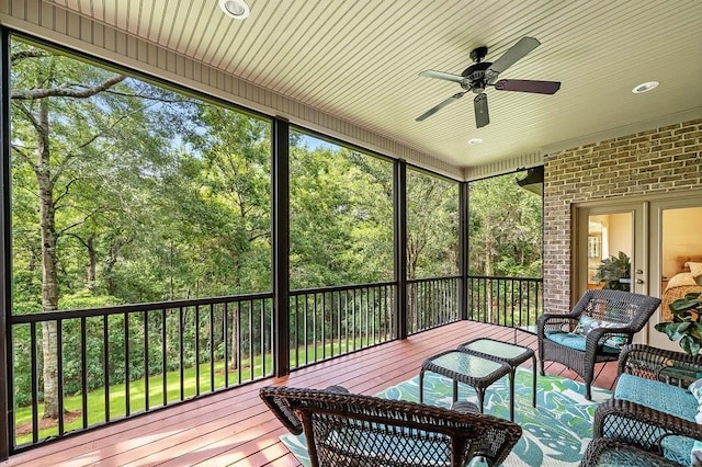 sunroom with a wealth of natural light and ceiling fan