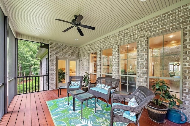 sunroom featuring ceiling fan