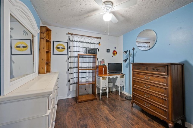 office space with dark wood-type flooring, ceiling fan, and a textured ceiling