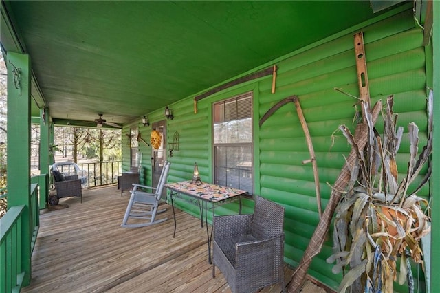 wooden terrace featuring ceiling fan and a porch