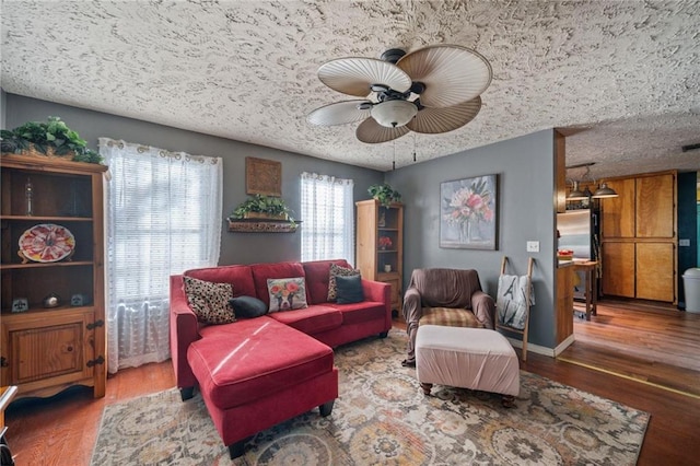 living room with ceiling fan and wood-type flooring