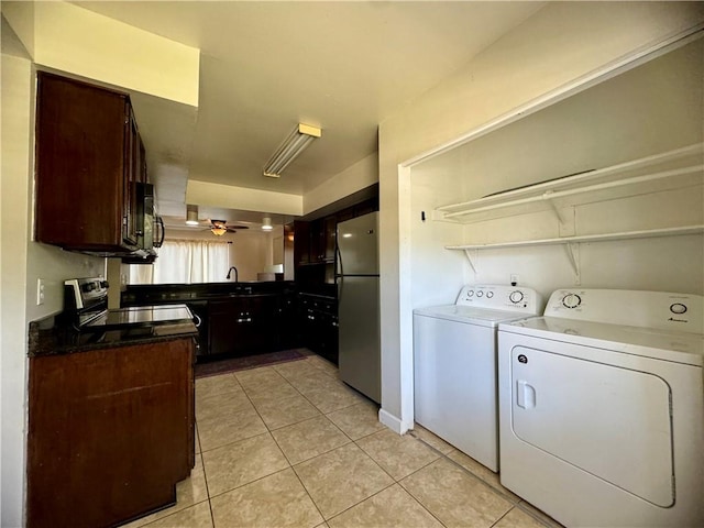 clothes washing area with light tile patterned floors, separate washer and dryer, sink, and ceiling fan