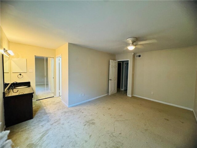 6701 Dickens Ferry Rd Unit 22, Mobile, AL 36608 - unfurnished bedroom with visible vents, a sink, baseboards, and light carpet