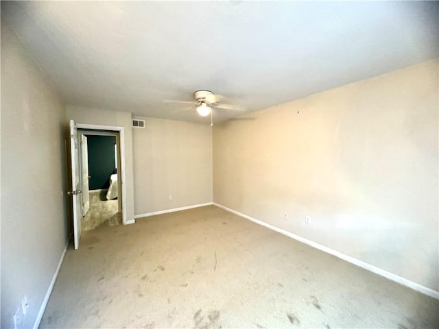 spare room with carpet floors and ceiling fan