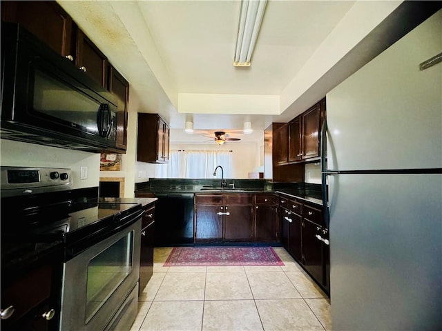 kitchen with light tile patterned flooring, sink, black appliances, dark brown cabinetry, and ceiling fan