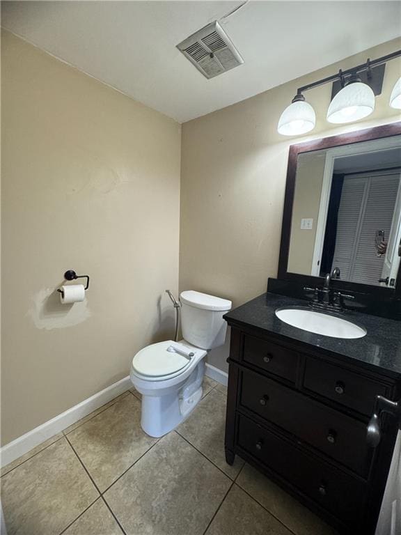 bathroom with tile patterned floors, vanity, and toilet