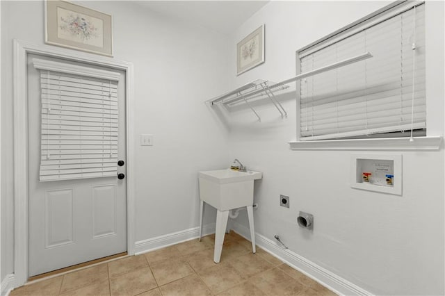 laundry area featuring light tile patterned floors, washer hookup, hookup for an electric dryer, and hookup for a gas dryer