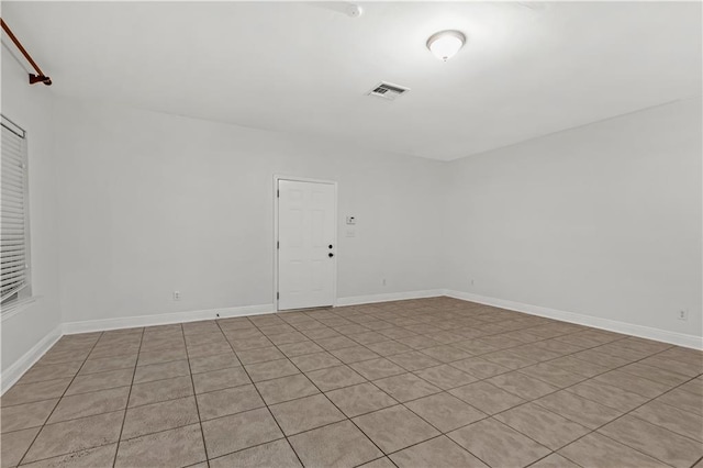 unfurnished room featuring light tile patterned floors