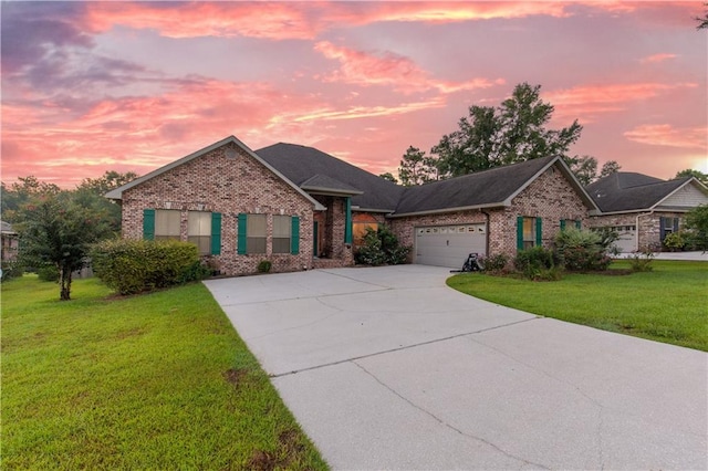 view of front of property with a yard and a garage