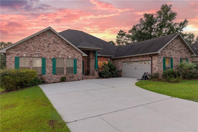 view of front of home featuring a lawn and a garage