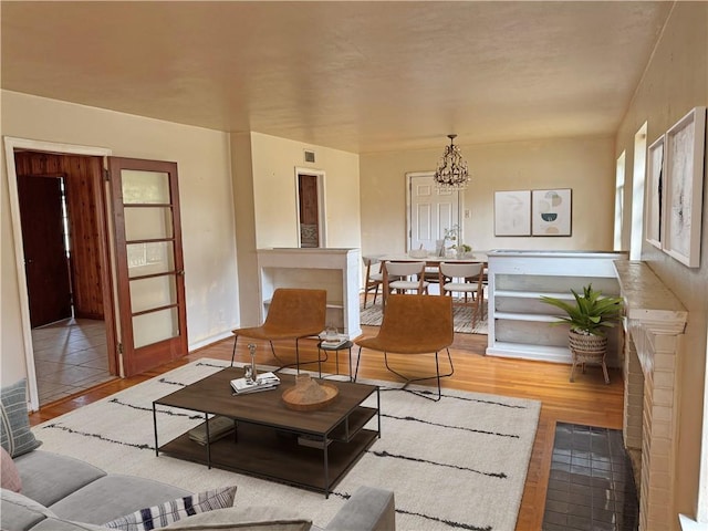 living room featuring a chandelier and wood finished floors