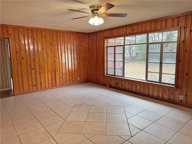 empty room with light tile patterned floors and wooden walls