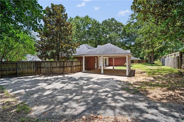 9996 Wedgefield Ct, Mobile, AL 36608 - fenced backyard featuring a patio area and a carport