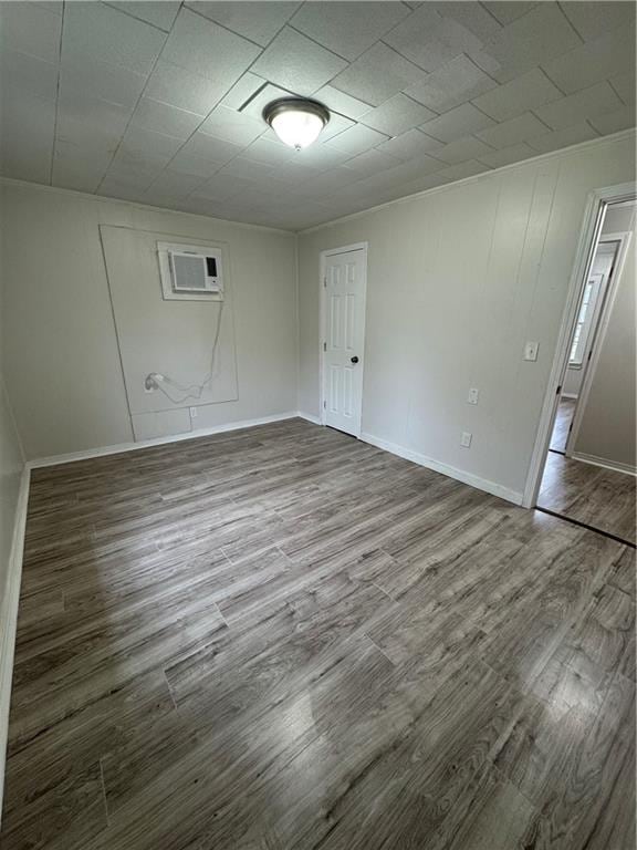 empty room with hardwood / wood-style flooring and a wall mounted air conditioner