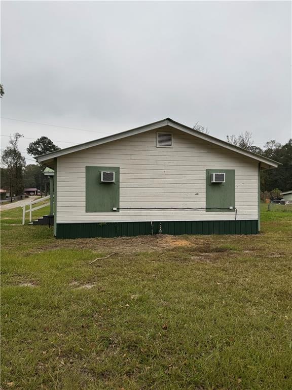 view of side of home featuring a lawn