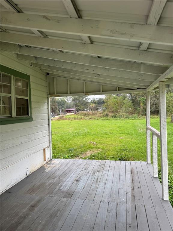 wooden terrace featuring a lawn