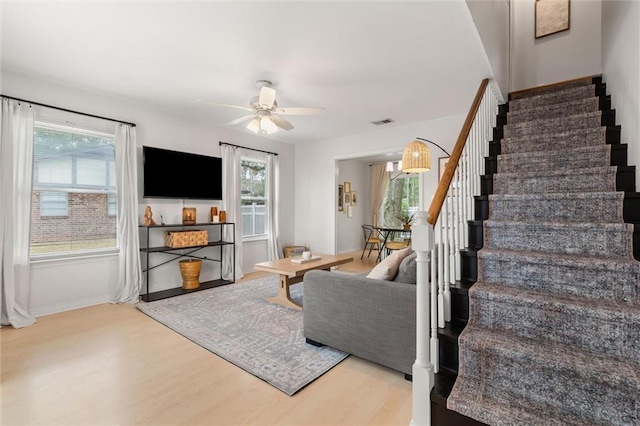 living room featuring hardwood / wood-style floors and ceiling fan