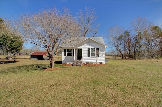 bungalow with entry steps, driveway, and a front yard