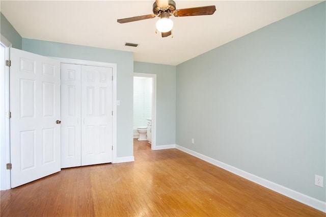 unfurnished bedroom featuring visible vents, a closet, light wood finished floors, baseboards, and ceiling fan