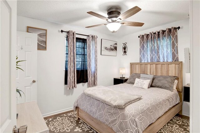 5023 Freeway Ln, Mobile, AL 36619 - bedroom featuring ceiling fan, dark wood-type flooring, and a textured ceiling