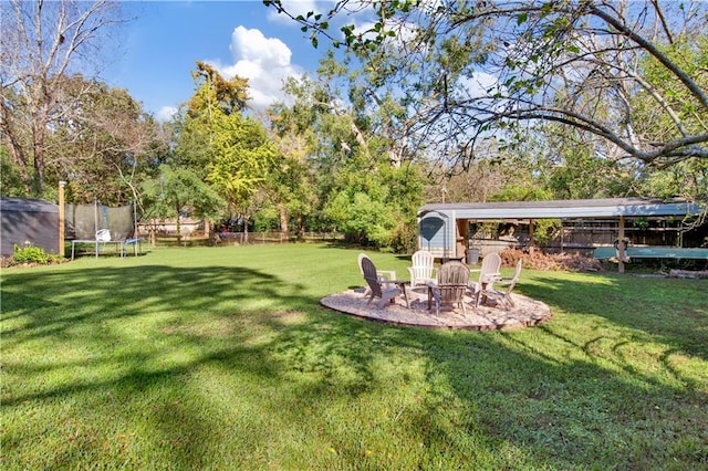 5023 Freeway Ln, Mobile, AL 36619 - view of yard featuring a trampoline and a fire pit