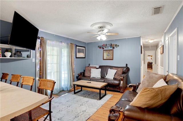 5023 Freeway Ln, Mobile, AL 36619 - living room with ceiling fan, a textured ceiling, and light wood-type flooring
