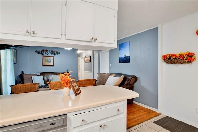5023 Freeway Ln, Mobile, AL 36619 - kitchen with dishwashing machine, white cabinets, and light tile patterned flooring