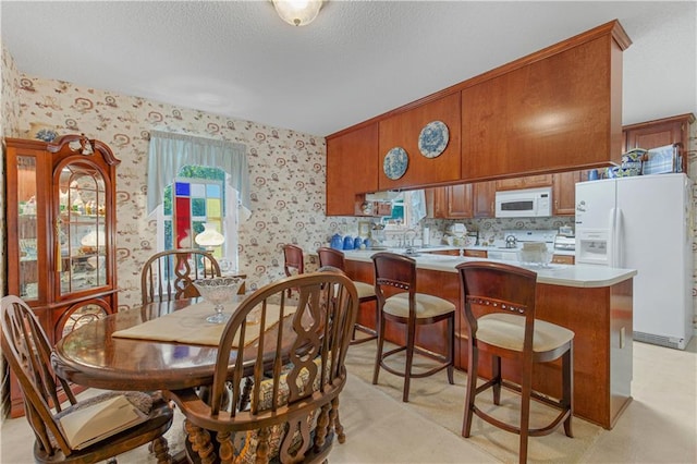 carpeted dining space with sink