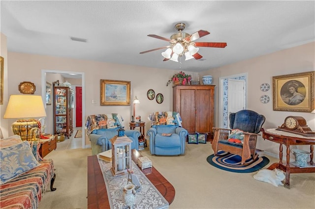 carpeted living room with ceiling fan