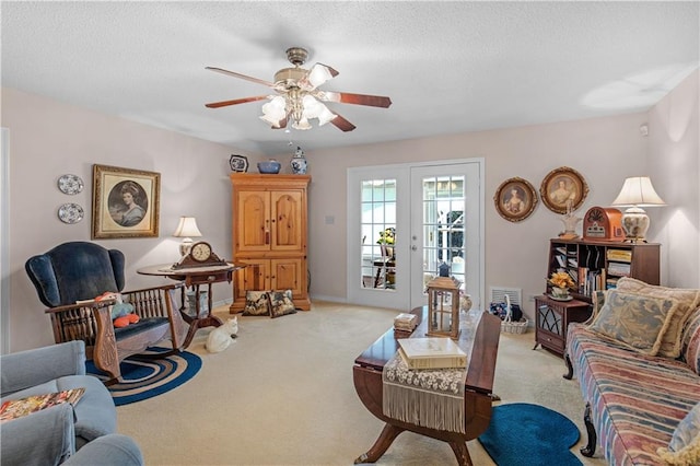 carpeted living room with french doors, a textured ceiling, and ceiling fan