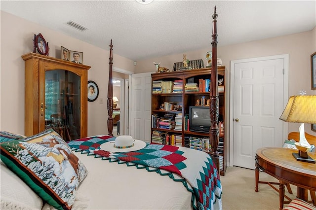 carpeted bedroom with a textured ceiling