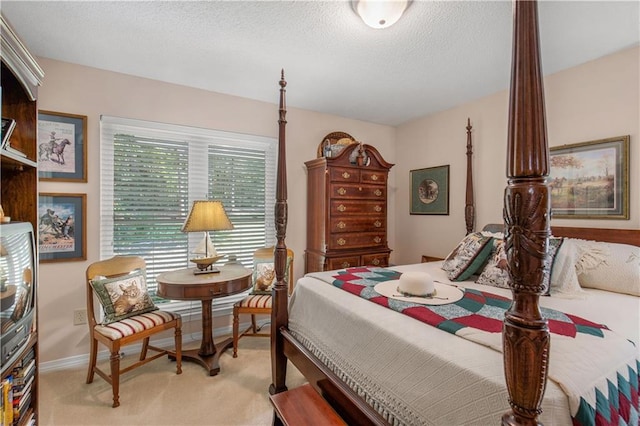 bedroom with light carpet and a textured ceiling